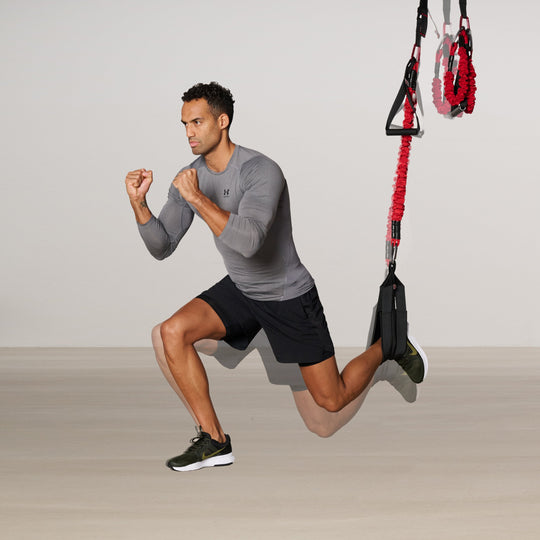 Man exercising with a 4D PRO® Bungee Trainer System trainer on a plain background