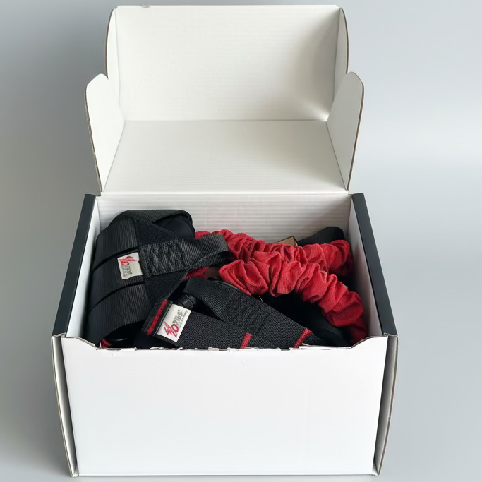 Box containing black and red belts with visible brand labels on