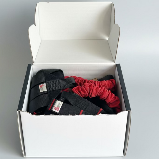Box containing black and red belts with visible brand labels on