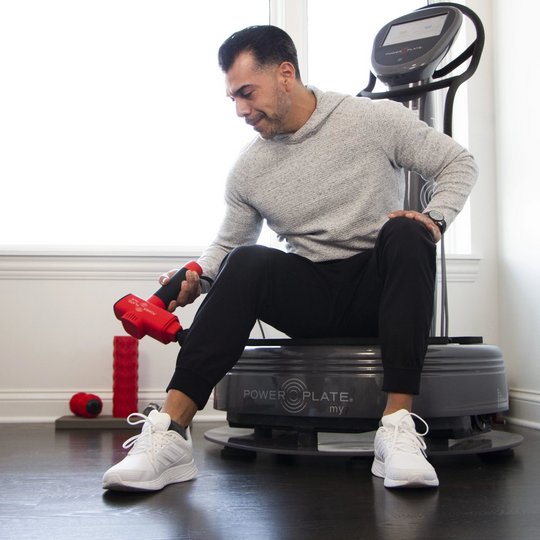 Man using a Power Plate Pulse red in a home setting

