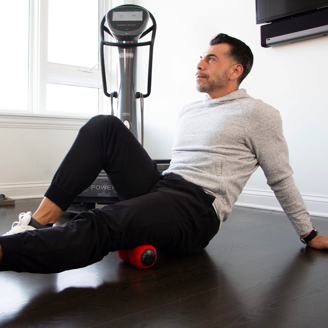 Man using a DualSphere on a wooden floor in a home setting.