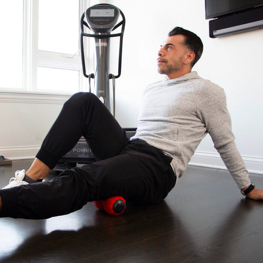 Man using a DualSphere on a wooden floor in a home setting.