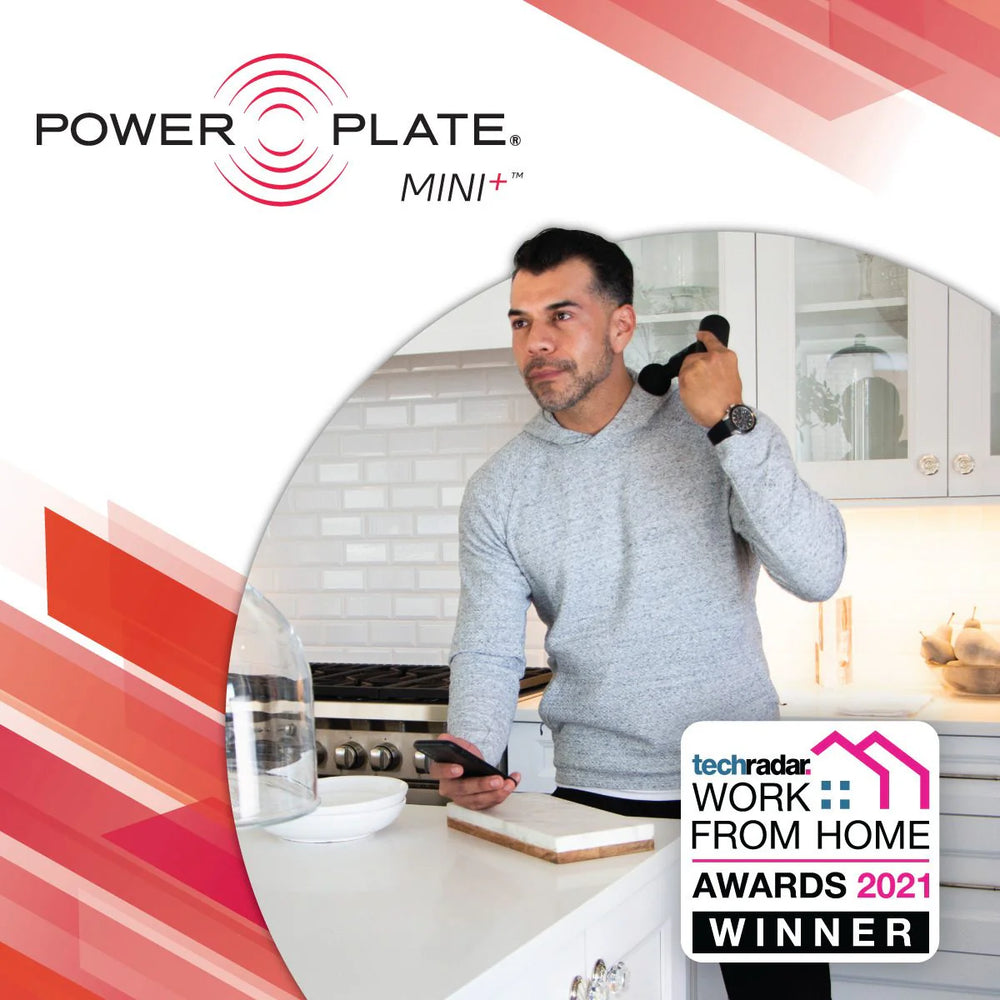 Man using Power Plate Mini+ device in a kitchen with TechRadar Work from Home Awards 2021 winner badge.