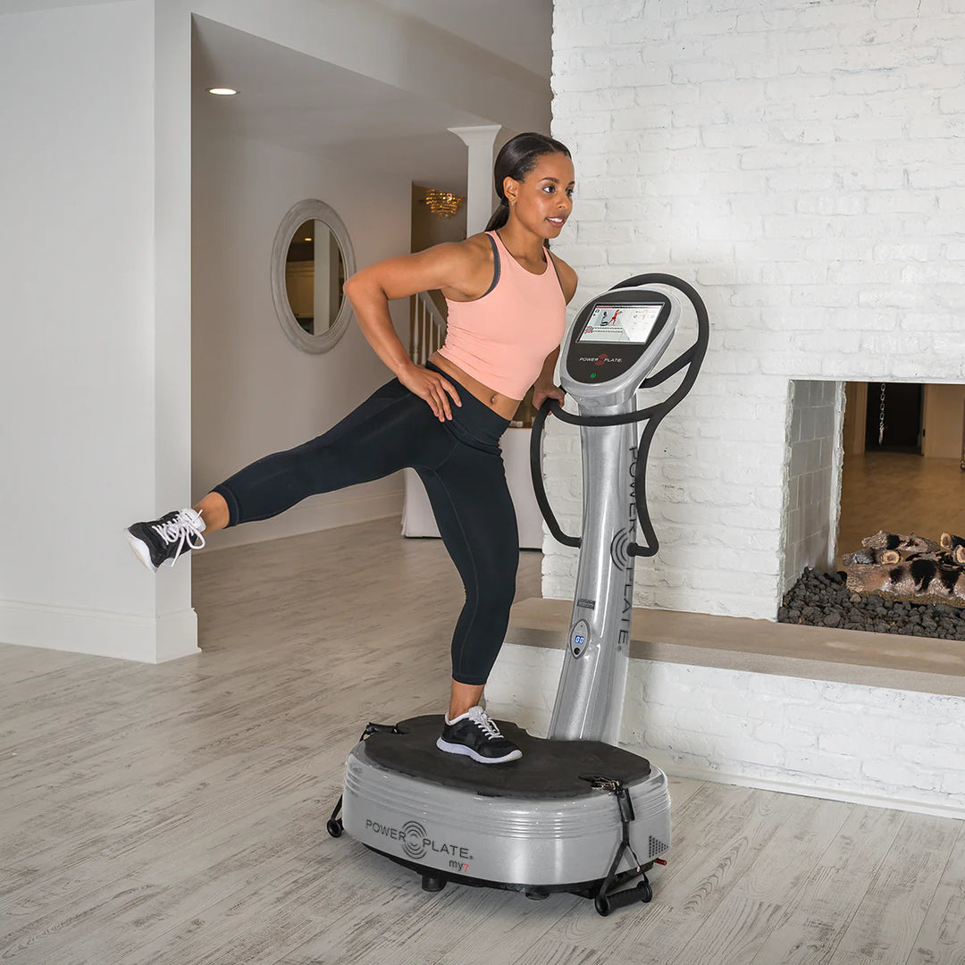 Woman using Power Plate® my7™ in a home setting