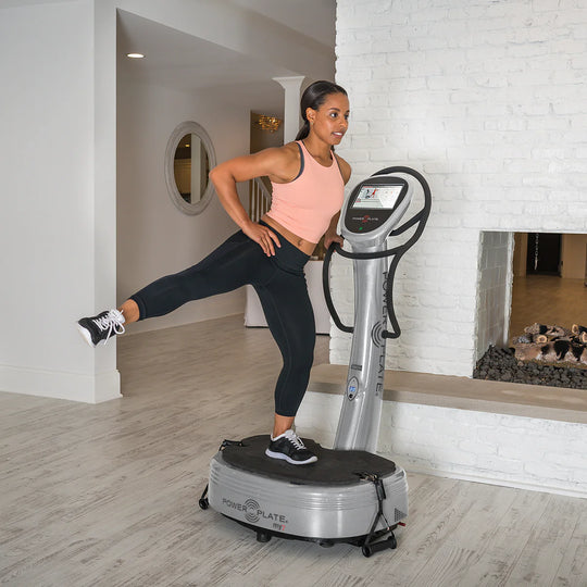 Woman using Power Plate® my7™ in a home setting